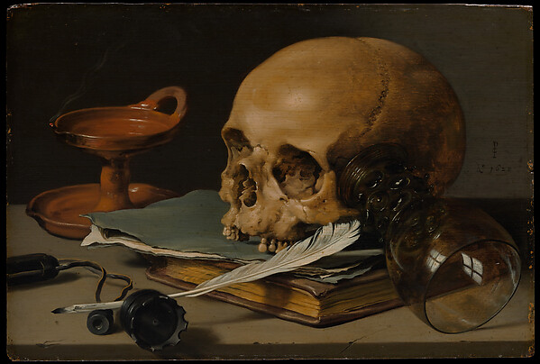 A skull, writing quill, books, lamp, and overturned glass arranged on a table.